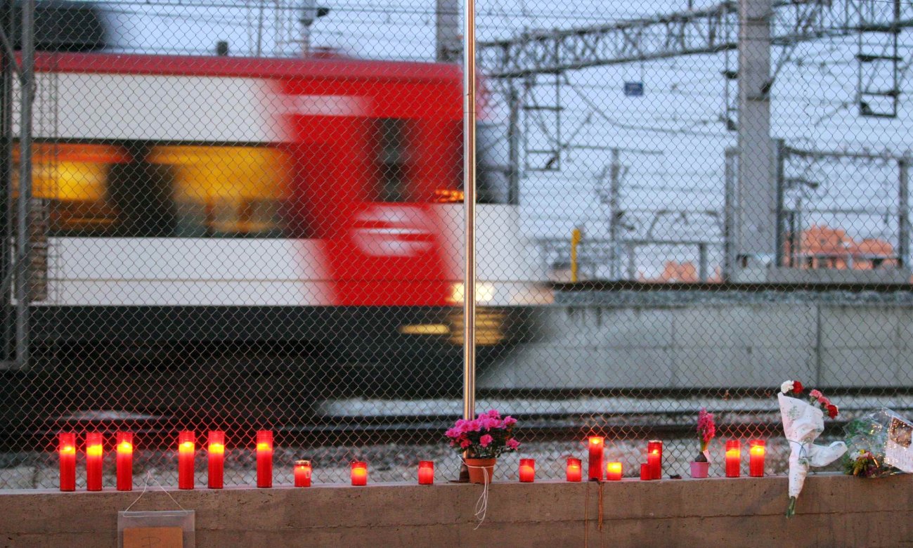 A woman lays flowers for the victims of Madrid's March 11, 2004 train bombings